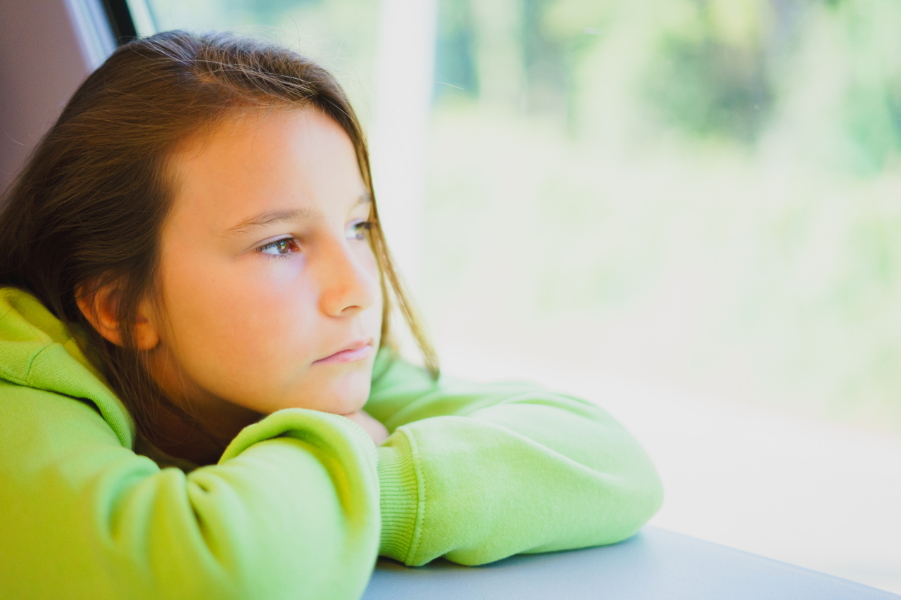 Close Up Portrait Of Little Cute Girl Who Is Sad While Traveling In Transport